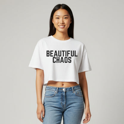 Person wearing a white t-shirt with 'BEAUTIFUL CHAOS' text on a plain background