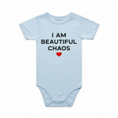 Light blue baby onesie with 'I AM BEAUTIFUL CHAOS' text and a red heart on a white background