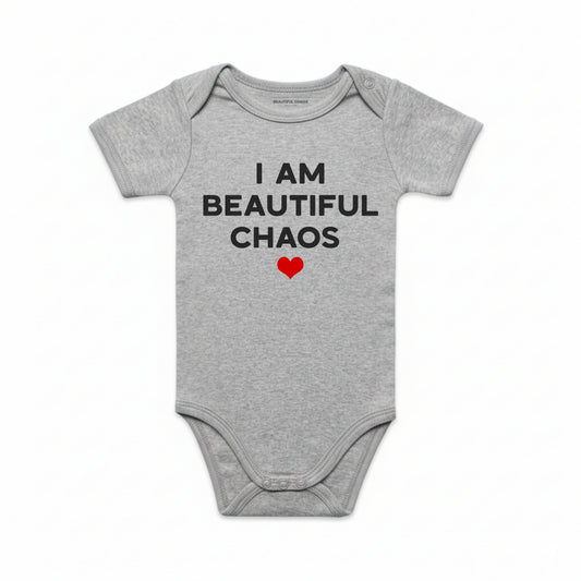 Gray baby onesie with text 'I AM BEAUTIFUL CHAOS' and a red heart