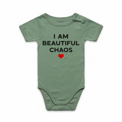 Sage Green baby onesie with text 'I AM BEAUTIFUL CHAOS' and a red heart on a white background